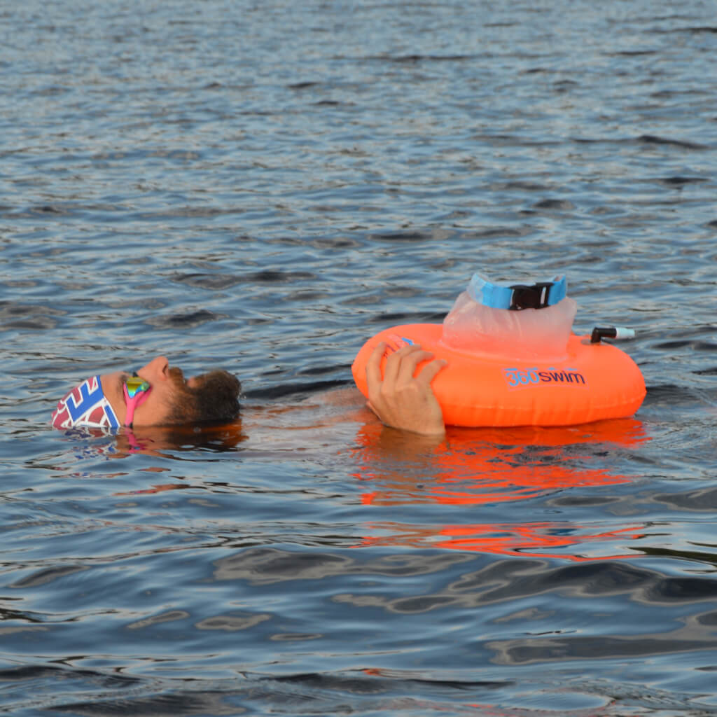 resting with swim buoy on back